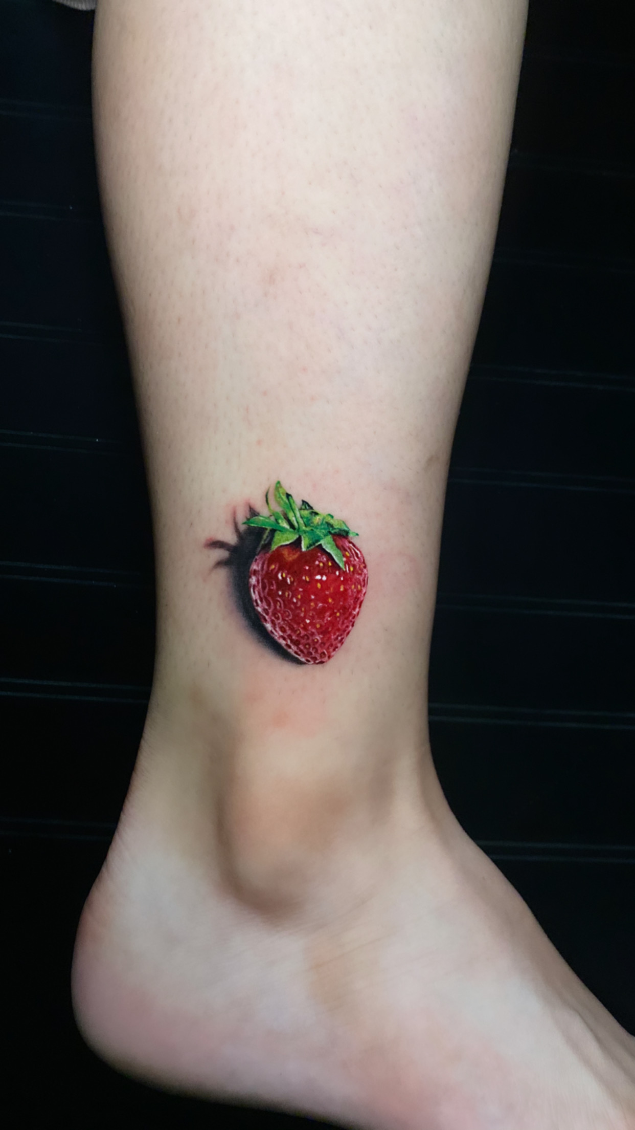 Pangea Ink 3D strawberry realism ankle tattoo
