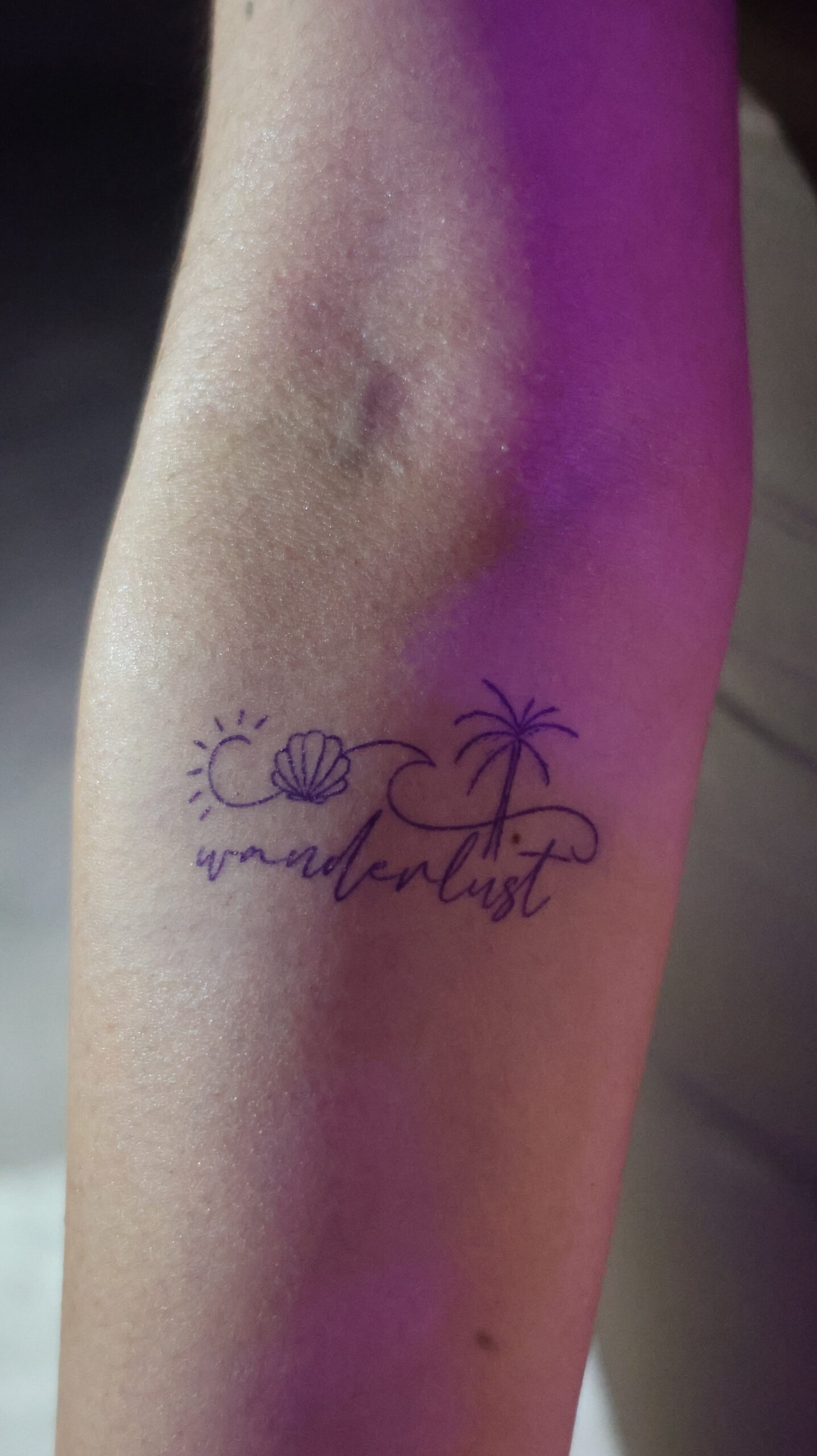 Pangea Ink UV blacklight wanderlust arm tattoo